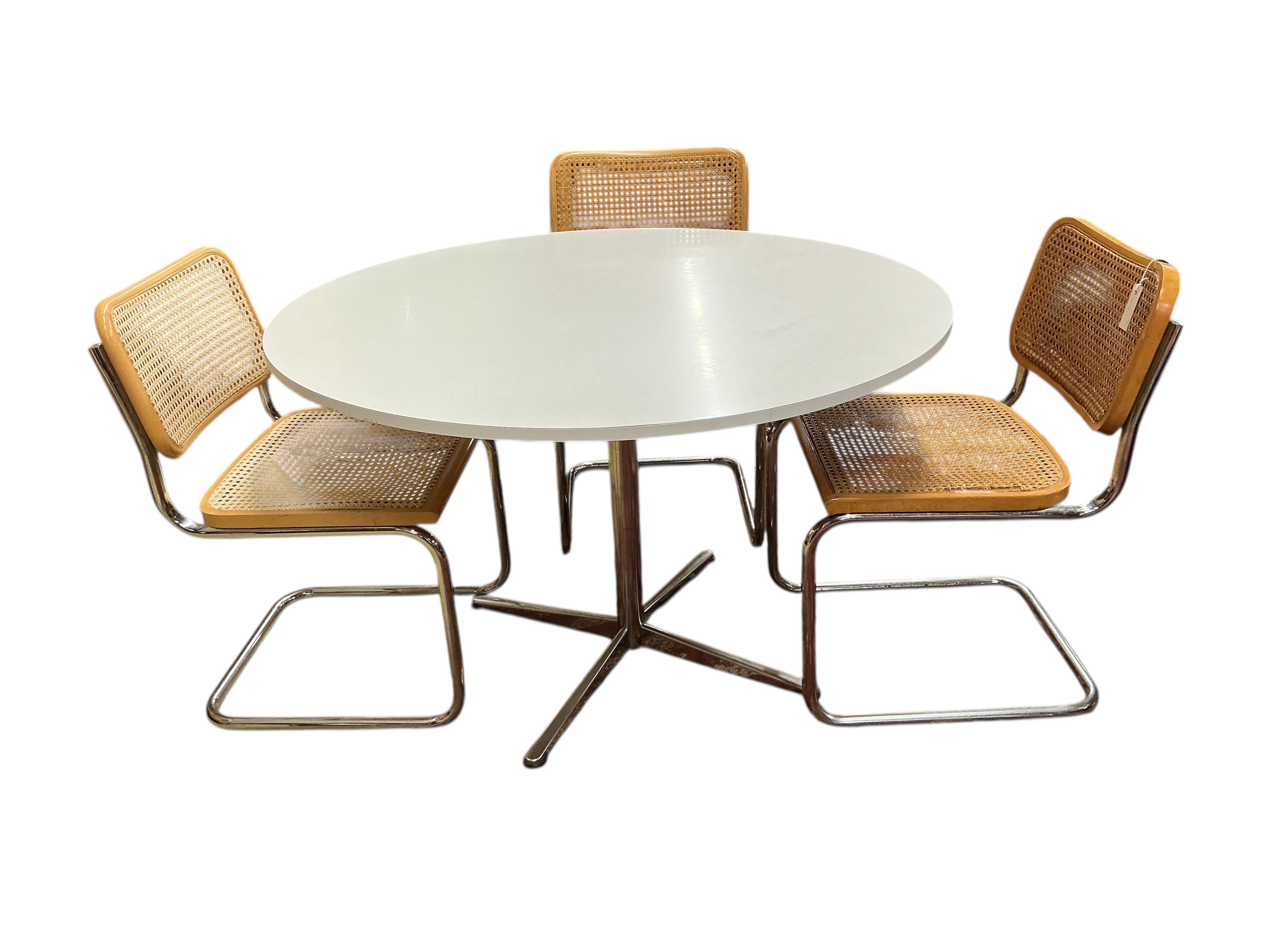 After Marcel Breuer a Cesca style circular table, diameter 112cm, height 72cm and four caned cantilever chairs, possibly Habitat.